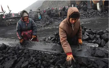  ?? — AFP ?? Falling demand: Workers sort coal on a conveyer belt near a coal mine in Datong, in China’s northern Shanxi province. China’s National Coal Associatio­n expects demand to decline in the second quarter on the year, after a fall of 6.8% in the first quarter as the virus shut industrial plants.