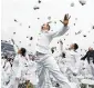  ?? AP ?? U.S. Naval Academy graduates celebrate at the end of the graduation and commission ceremony in Annapolis, Md.