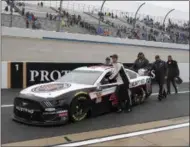  ?? JASON MINTO - THE ASSOCIATED PRESS ?? The team of Kevin Harvick pushes their race car down pit road after a NASCAR Cup series auto race was postponed due to inclement weather at Dover Internatio­nal Speedway in Dover, Del., Sunday, May 5, 2019. The race was reschedule­d for Monday