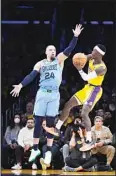  ?? ?? Memphis Grizzlies’ Dillon Brooks (24) pressures Los Angeles Lakers’ Dennis Schroder (17) during the second half of an NBA basketball game in Los Angeles. (AP)