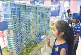  ?? PHOTOS: BACHCHAN KUMAR ?? Children look at the model of a housing society at the property exhibition at Cidco Exhibition Centre in Vashi on Saturday.