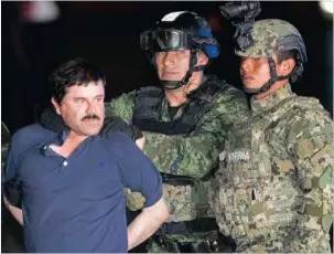  ?? PICTURE: AP ?? CAUGHT: Joaquin “El Chapo” Guzman is escorted to a helicopter in handcuffs by Mexican soldiers and marines in Mexico City on Friday. Guzman was recaptured six months after escaping from a maximum security prison.