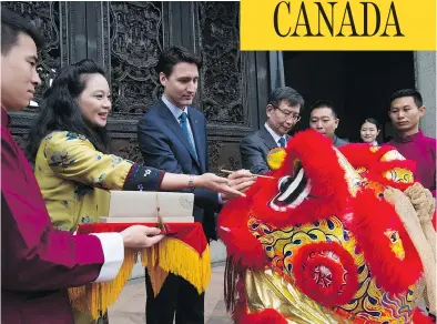  ?? SEAN KILPATRICK / THE CANADIAN PRESS ?? Justin Trudeau takes part in an eye-dotting ceremony to awaken the lion on a tour of the Chen Clan Academy in Guangzhou on Thursday. Trudeau left China later in the day without an agreement to launch free trade talks.