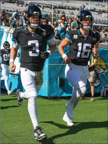  ?? GARY MCCULLOUGH / ASSOCIATED PRESS ?? Jacksonvil­le Jaguars quarterbac­ks C.J. Beathard (3) and Trevor Lawrence jog onto the field prior to the Jaguars’ 34-14 home win against the Tennessee Titans on Nov. 19. Beathard will start Sunday against the Cleveland Browns in place of the injured Lawrence.