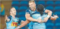  ?? Picture: GETTY IMAGES ?? CELEBRATIO­N: Titans Kane Elgey and Bryce Cartwright celebrate Konrad Hurrell's try against the Raiders.