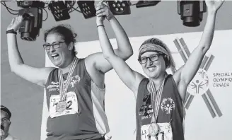  ?? Corey Leblanc ?? Kristina Richard (left) and her friend and Team Nova Scotia teammate Sasha Repko of Port Hawkesbury celebrate on the medal podium during the 2018 Special Olympics Canada Summer Games in Antigonish.