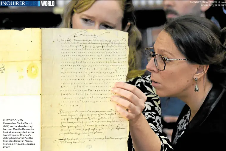  ?? BY AFP —PHOTOS MONDAY / NOVEMBER WWW.INQUIRER.NET ?? PUZZLE SOLVED Researcher Cecile Pierrot (left) and modern history lecturer Camille Desenclos look at an encrypted letter from Emperor Charles V dating back to 1547 at the Stanislas library in Nancy, France, on Nov. 23.