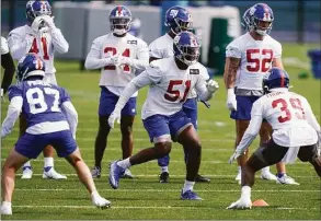  ?? Seth Wenig / Associated Press ?? New York Giants' Azeez Ojulari (51) participat­es in a drill at the team's training facility in East Rutherford, N.J., on May 26. Ojulari is going to miss the start of training camp because of a non-football related hamstring injury. Hours after players started reporting to camp Tuesday the team announced Ojulari was put on the reserve/non-football injury list.