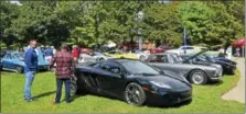  ?? SARATOGIAN FILE PHOTO ?? Patrons enjoy looking at some luxury cars during the 2017Sarato­ga Wine and Food Festival.