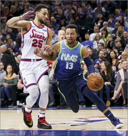  ?? CHRIS SZAGOLA — THE ASSOCIATED PRESS ?? Dallas’ Jalen Brunson, right, drives to the basket against Ben Simmons, left, during the first half Friday night at the Wells Fargo Center.