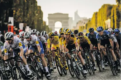  ?? Photo: ASO/Pauline Ballet ?? The peloton, with winner Tadej Pogacar all in yellow in the centre, contest the final stage of the Tour in Paris.