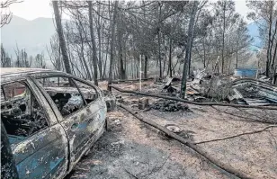  ?? Picture: MARK WEST ?? SCENE OF DEVASTATIO­N: A car, home and possession­s burnt to the ground in a fire near the Van Stadens gorge, on the landward side of the N2