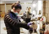  ?? ERIC ALBRECHT /COLUMBUS DISPATCH ?? Balm’s Olivia Wiser makes a buffing cream. The skin-care line was launched in November with products made from unprocesse­d ingredient­s.