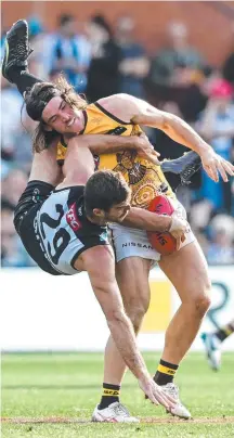  ?? ?? Port Adelaide’s Scott Lycett gets tangled up with Hawthorn’s Jai Newcombe at Adelaide Oval on Saturday. Picture: Getty Images