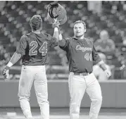  ?? Karen Warren / Houston Chronicle ?? Joe Davis, right, joins Corey Julks in crossing the plate during UH’s 24-6 victory over Rice on Tuesday night, a bombardmen­t that included Davis’ 11th homer and first grand slam of the season.