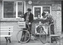  ?? PROVIDED TO CHINA DAILY ?? Wei Hanye, left, co-founder of the Berry Beans cafe in Beijing, makes coffee on his bike.