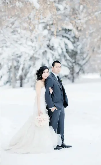  ??  ?? Edubart Quiza and Connie Cheung are photograph­ed in the river valley near Irene Parlby Park on their wedding day, Nov. 23, 2013.