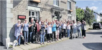  ??  ?? ●●Members of the community who have bought their local, the Northumber­land Arms in Marple Bridge