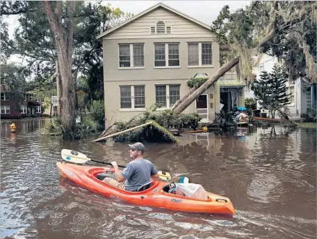  ?? Photograph­s by Carolyn Cole Los Angeles Times ?? “WE WOKE up, and all of a sudden, we were part of the river,” said Joshua Young, whose Jacksonvil­le, Fla., apartment building f looded.