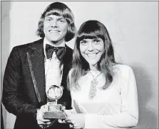  ?? [AP FILE PHOTO] ?? Richard and Karen Carpenter, holding a Grammy Award the sibling duo won in 1970