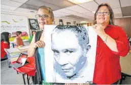  ?? JACOB LANGSTON/STAFF PHOTOGRAPH­ER ?? Maria Rodriguez, left, and Millie Matos Arroyo, show the painting that they worked on of their friend Franky Jimmy DeJesus Velasquez.