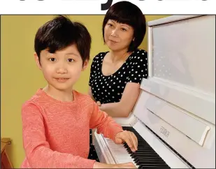  ??  ?? Piano prodigy: Seven-year-old Leo Bailey-Yang with his mother Yulan