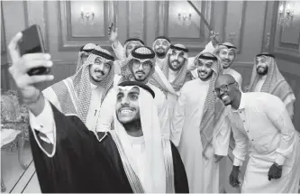  ?? AFP-Yonhap ?? Saudi groom Basil Albani poses for a selfie with his friends during his wedding at his home in the Red Sea resort of Jeddah, Sept. 6, 2018.