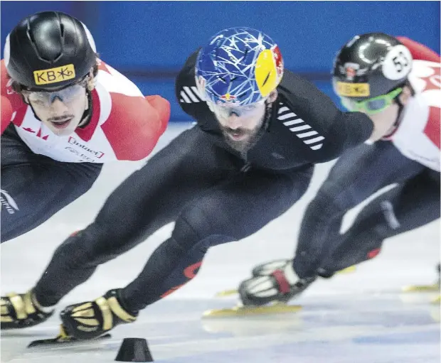  ?? PAUL CHIASSON / THE CANADIAN PRESS ?? Canada’s Charles Hamelin, centre, a four-time Olympic medallist in short-track speedskati­ng, found himself battling a slump early in the World Cup season before breaking through for gold at a 2018 Winter Games test event in South Korea last month.