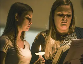  ?? KENNY HOLSTON/THE NEW YORK TIMES ?? People attend a vigil Wednesday for victims of the mass shooting in Chesapeake, Va.