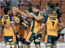  ?? PHOTOSPORT ?? Brumbies players celebrate during their upset win over the Chiefs in Hamilton on Saturday.