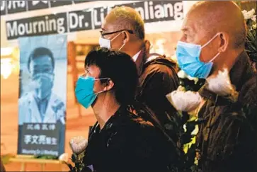  ?? Anthony Kwan Getty Images ?? A VIGIL in Hong Kong honors Dr. Li Wenliang, who died from the coronaviru­s after having been punished for trying to warn of the danger. “I want freedom of speech” was trending online before censors scrubbed it.