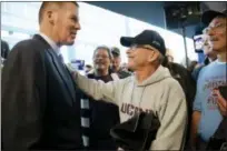  ?? AP FILE PHOTO ?? Robert Foberg of East Hampton, center, congratula­tes Randy Edsall, left, on his return as the Connecticu­t football coach in December 2016.