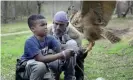  ??  ?? Rodney Stotts teaches student Javiare Harris to pick up his Eurasian eagle owl, Mr Hoots. Photograph: Annie Kaempfer