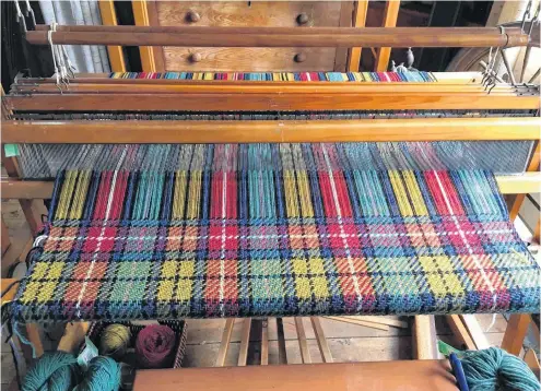  ?? CHRISTOPHE­R CONNORS ?? The family tartan Amber Buchanan is weaving on her loom.