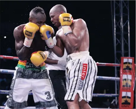  ?? Picture: CHRISTIAN THOMPSON, BACKPAGEPI­X ?? ON THE BUTTON: South Africa’s Mzonke Fana connects with Emmanuel Tagoe during their IBO world lightweigh­t title bout at the Bukom boxing arena in Accra, Ghana, which Fana lost.