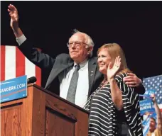  ?? BRENNAN LINSLEY, AP ?? Sen. Bernie Sanders and his wife, Jane, wave to supporters at a campaign rally in Laramie, Wyo., on Tuesday.