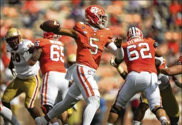  ?? JOSHMORGAN/ POOL PHOTOVIA AP ?? With Trevor Lawrence sitting out because of COVID- 19, backupQB D. J. Uiagalelei ( 5) helped rallyNo. 1 Clemson against Boston College lastweek. Uiagalelei will start again Saturday at No. 4 Notre Dame.