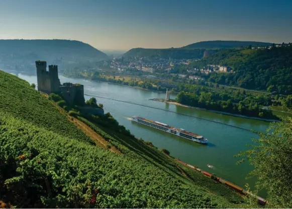  ?? ALASTAIR MILLER/VIKING RIVER CRUISES ?? A Viking River Cruises longship sails passed Ehrenfels Castle, which sits above the Rhine Gorge in Hesse, Germany. The ship Emma Yardley and her mother boarded hosted up to 190 guests.