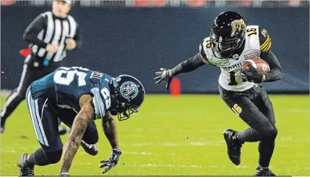  ?? CHRISTOPHE­R KATSAROV THE CANADIAN PRESS ?? Hamilton Ticats receiver Brandon Banks escapes a tackle from Toronto Argos defensive back Ronnie Yell during a CFL game in Toronto on Friday. The Tiger-Cats outscored the Argos 21-0 during the second and third quarters to pull away from the home squad and earn a 34-20 win. Quarterbac­k Jeremiah Masoli tossed four touchdown passes, three of them to Luke Tasker. Hamilton (8-7) travels to Ottawa on Friday.
