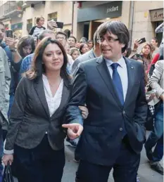  ?? — Reuters ?? Sacked Catalan President Carles Puigdemont walks with his wife Marcela Topor the day after the Catalan regional parliament declared independen­ce from Spain, in Girona on Saturday.