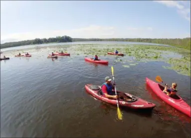  ?? JONATHAN TRESSLER — THE NEWS-HERALD ?? Participan­ts in the Geauga Park District’s Adventure Day Camp, along with their counselors, set out in kayaks July 17 on Bass Lake. The weeklong Adventure Daycamps introduce youths to a variety of outdoor activities.