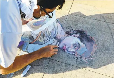  ?? EDUARDO CONTRERAS U-T ?? Erick Toussaint works on a chalk re-creation of Bouguereau’s 1885 ‘The Young Shepherdes­s” outside his Ocean Beach home on Friday.