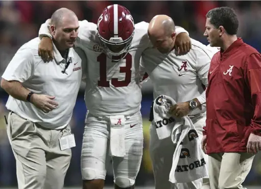  ?? The Associated Press ?? Tua Tagovailoa limps off the field in the SEC title game. Some have speculated that his injury hurt his chances of winning the Heisman.