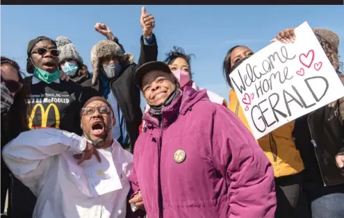  ?? TYLER LARIVIERE/SUN-TIMES ?? Gerald Reed (white shirt) and his mother, Armanda Shackelfor­d, celebrate with supporters Friday outside Stateville Correction­al Center.