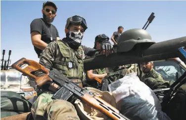  ?? Abdullah Doma / AFP via Getty Images ?? Members of eastern forces led by military commander Khalifa Hifter gather in Benghazi in June.