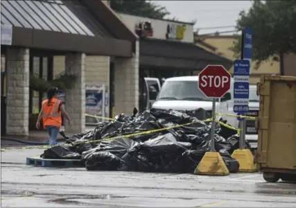  ?? RYAN WELCH — THE ASSOCIATED PRESS ?? Bags of trash are piled in front of Kroger grocery store in Beaumont, Texas, after the area east of Houston was hit by more than 40 inches of rain from Tropical Storm Imelda. At least five related deaths have been reported.