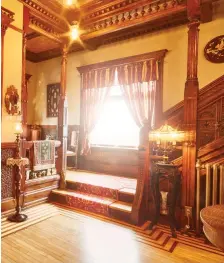  ??  ?? This spread Top photo: the couple’s second-story bedroom. Bottom left: More intricate floor-to-ceiling woodwork. Bottom right: Tim Baack, left, and his partner John Sheaffer on a settee with two of their three dogs.