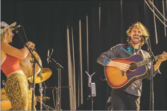  ?? NATHAN BURTON/Taos News ?? Andrea Magee, left, and Ben Jones of Beat Root Revival deliver an energetic performanc­e during the Big Barn Dance.