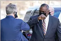  ?? ALEX BRANDON / AP ?? Defense Secretary Lloyd Austin, right, greets Deputy Secretary of Defense David Norquist as he arrives at the Pentagon Friday in Washington.