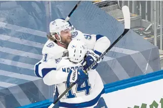  ?? Jason Franson, The Canadian Press ?? Tampa Bay Lightning center Steven Stamkos ( 91) celebrates his goal against the Dallas Stars with left wing Patrick Maroon ( 14) during the first period of Game 3.